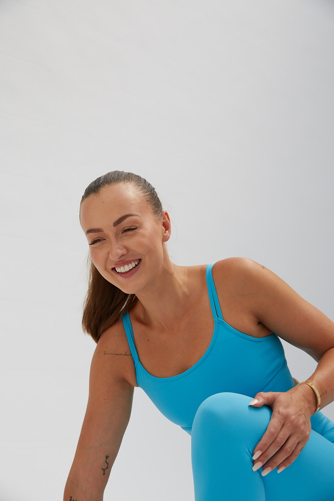 Image of a fitness woman smiling on white backdrop